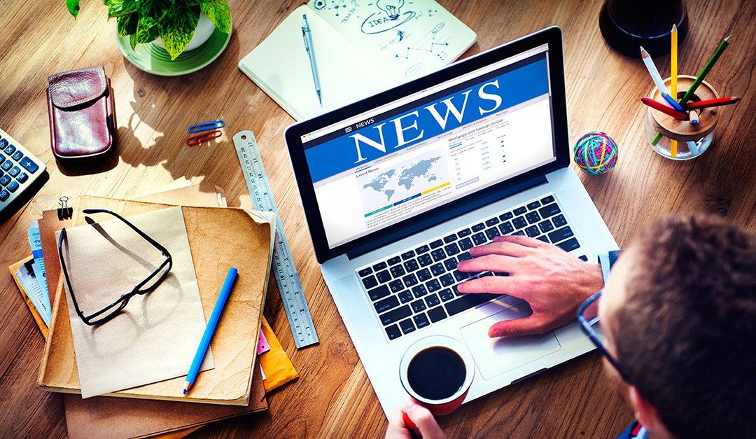 A media professional reviewing a news website during digital PR research