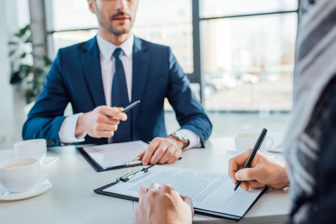 Business representatives discussing campaign responsibilities before signing an agreement