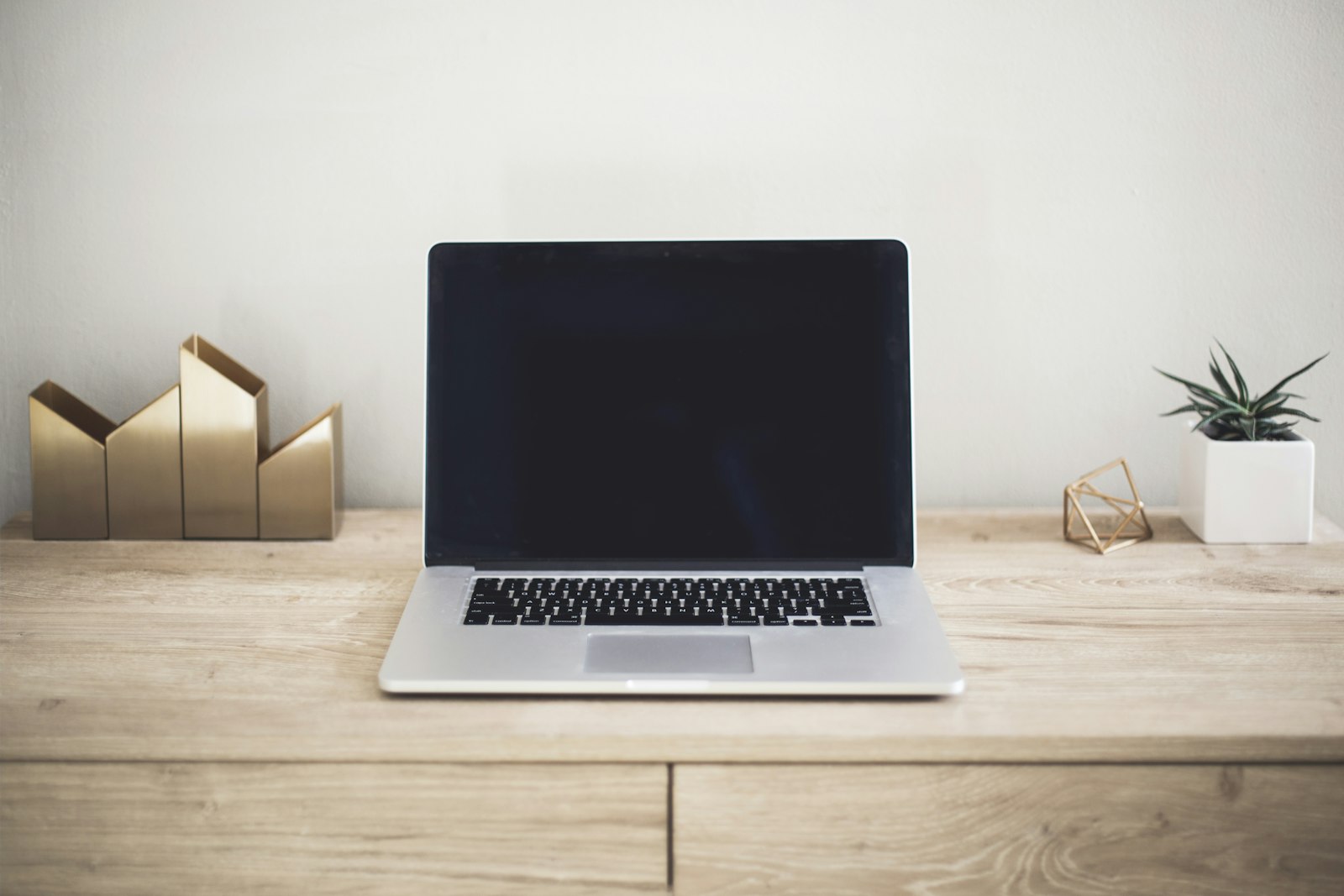 Laptop on a wooden desk ready for writing