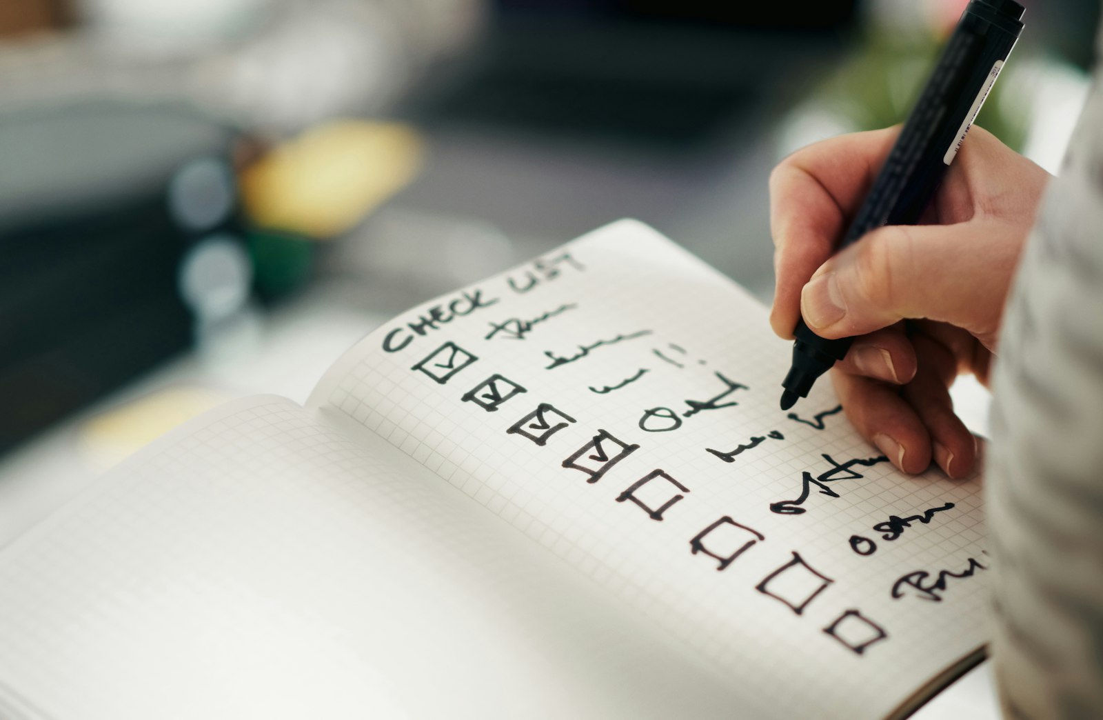 Person ticking items off a printed checklist