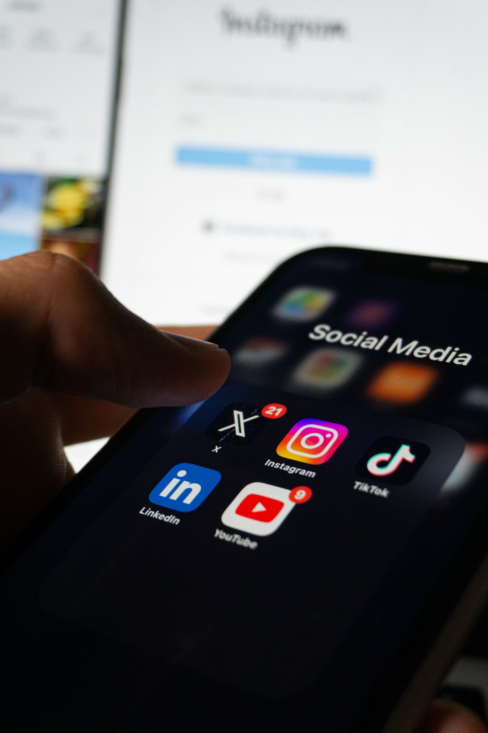 Person holding a smartphone with social media apps